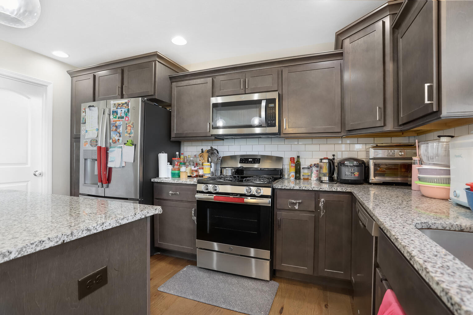 807 Cates Drive Mahomet, IL 61853 - Photo 9 of 33 a kitchen with stainless steel appliances granite countertop a sink stove and refrigerator