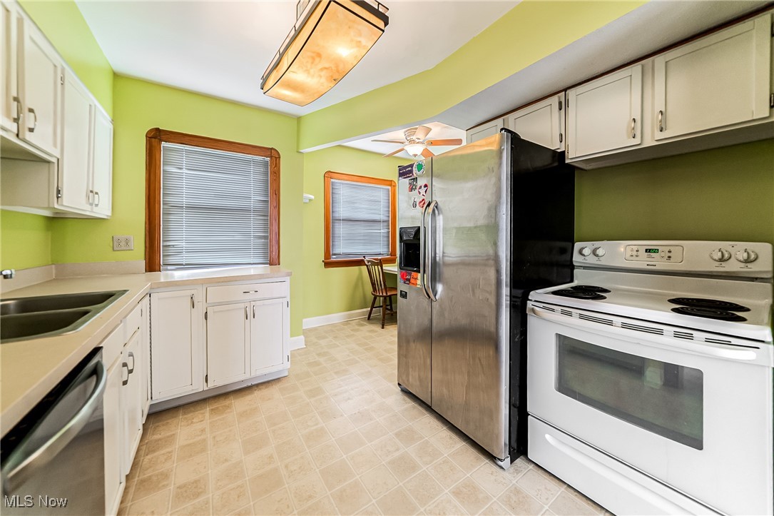 6711 Forest Avenue Parma, OH 44129 - Photo 12 of 33 Kitchen with stainless steel appliances, white cabinets, light countertops, and ceiling fan