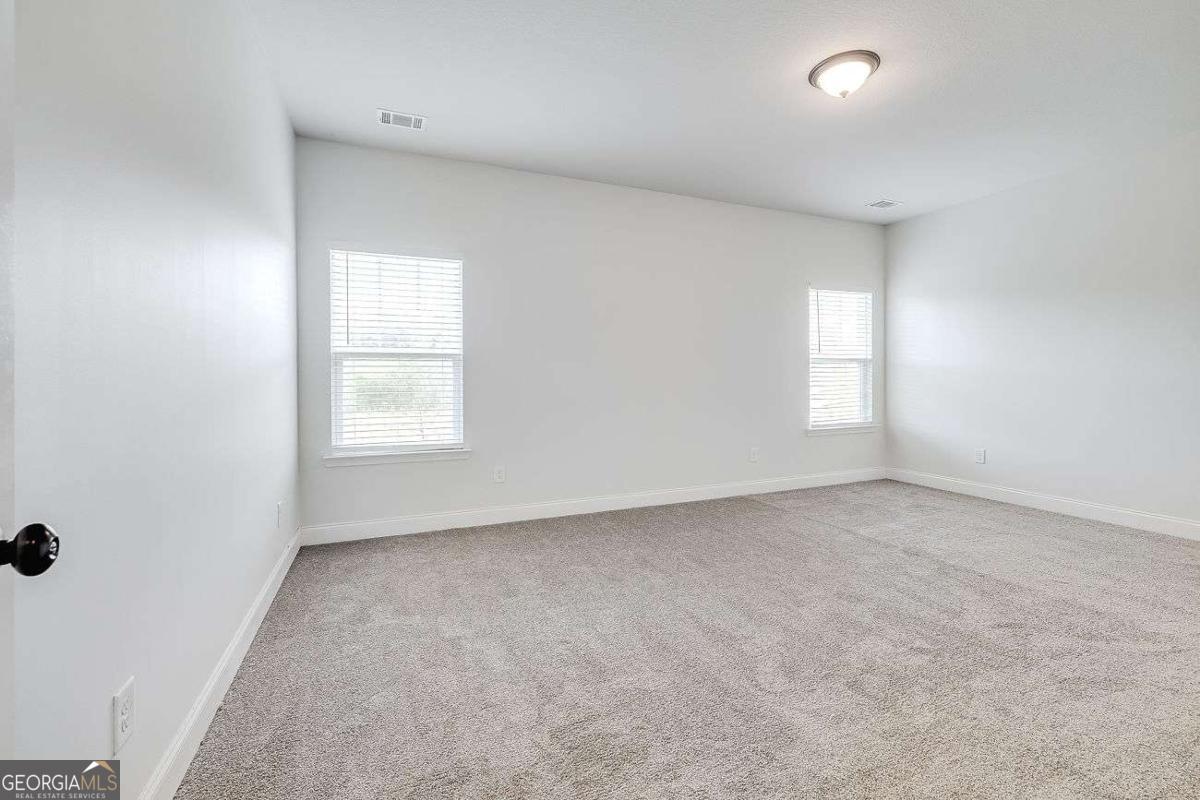 208 Timberlake Lane Guyton, GA 31312 - Photo 12 of 24 an empty room with windows
