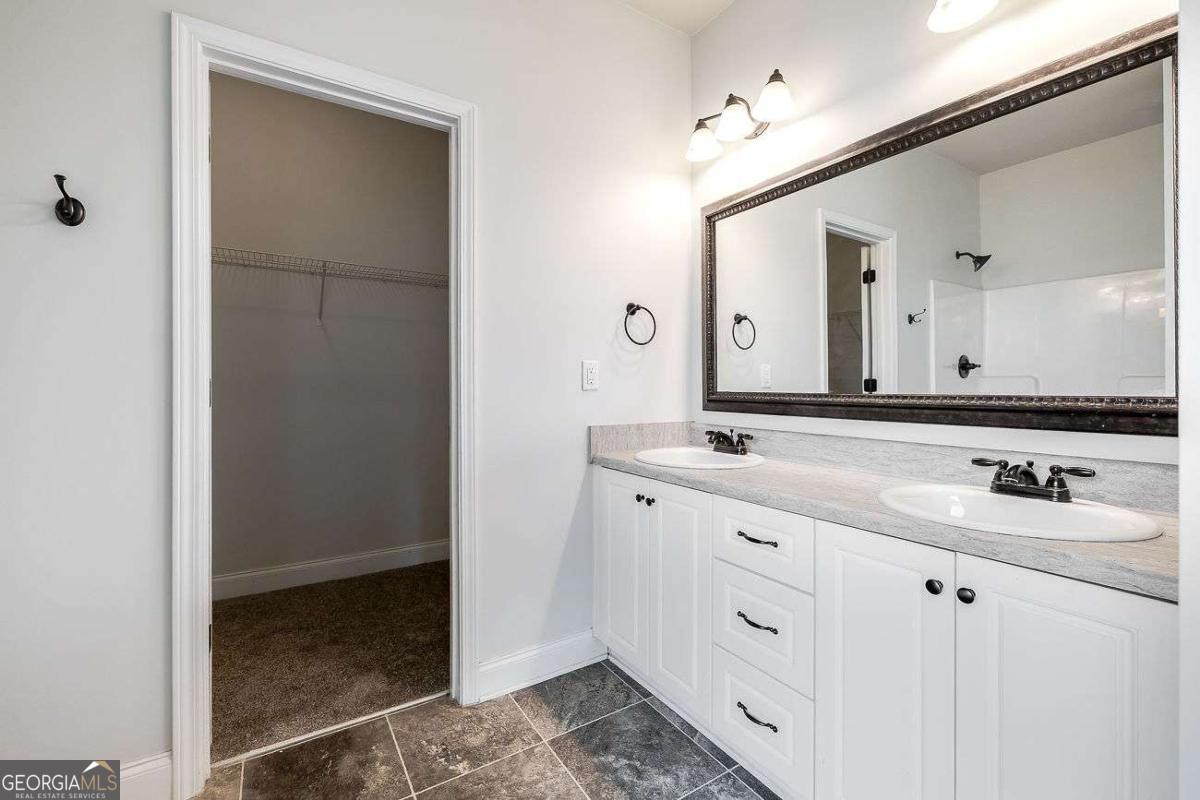 208 Timberlake Lane Guyton, GA 31312 - Photo 16 of 24 a bathroom with a double vanity sink and mirror