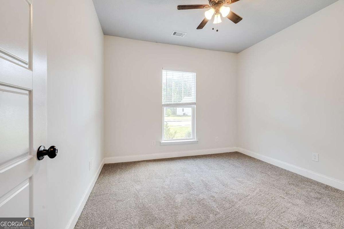 208 Timberlake Lane Guyton, GA 31312 - Photo 19 of 24 wooden floor in an empty room with a window