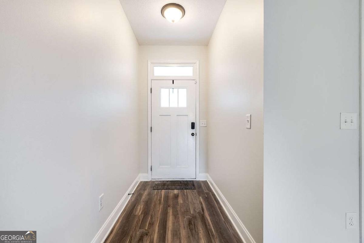208 Timberlake Lane Guyton, GA 31312 - Photo 2 of 24 a view of a hallway with wooden floor