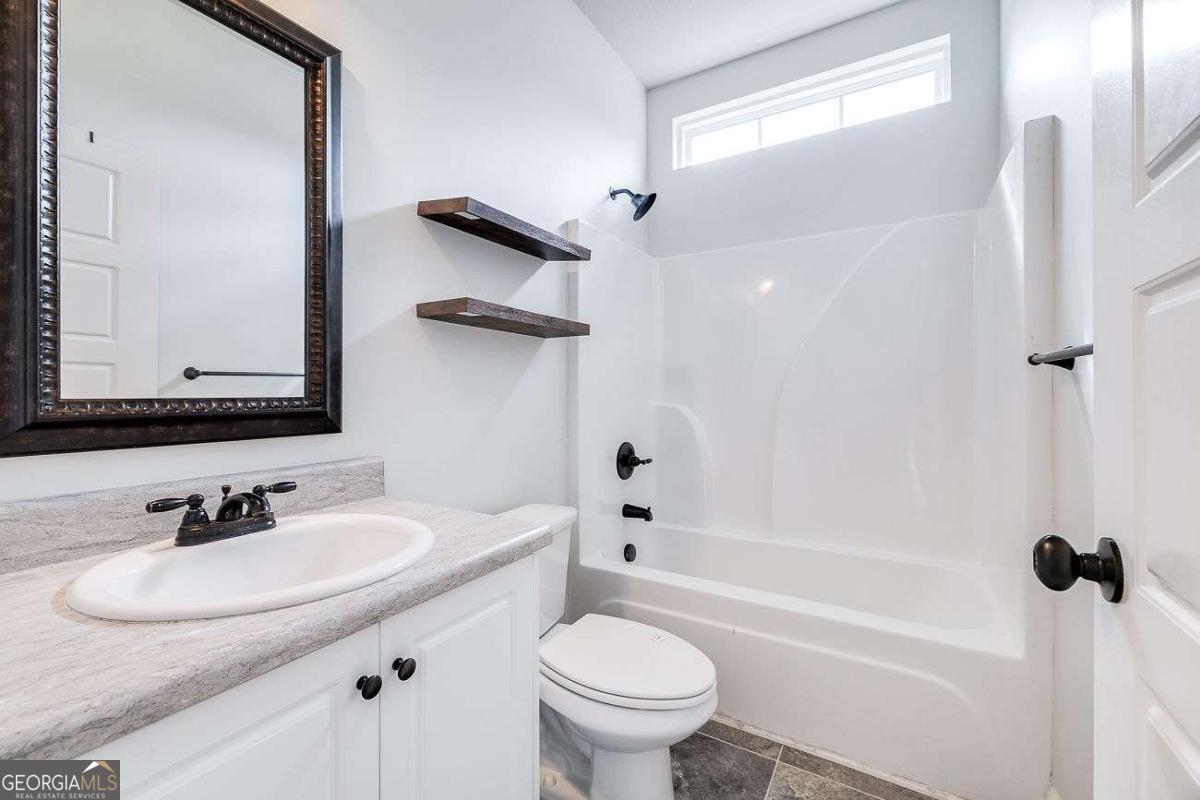 208 Timberlake Lane Guyton, GA 31312 - Photo 21 of 24 a bathroom with a sink toilet tub and shower