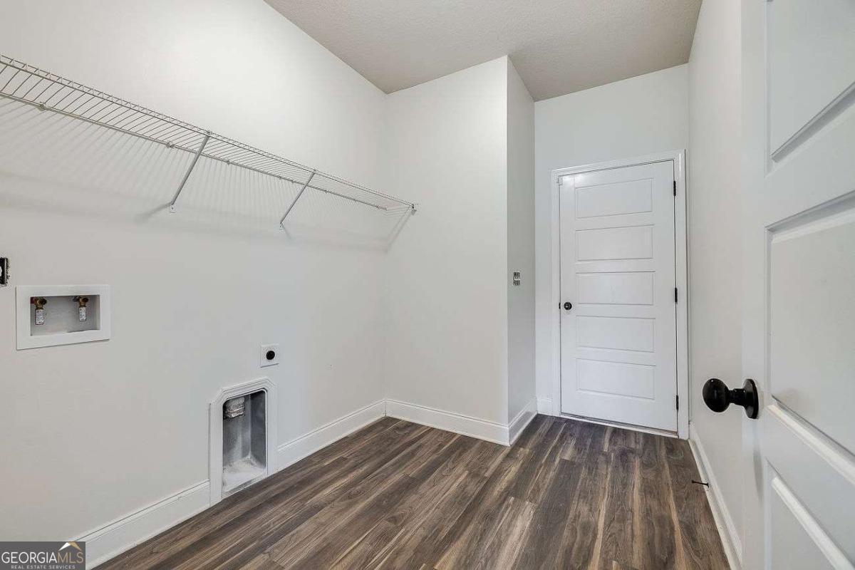 208 Timberlake Lane Guyton, GA 31312 - Photo 24 of 24 a view of a room with wooden floor and white walls