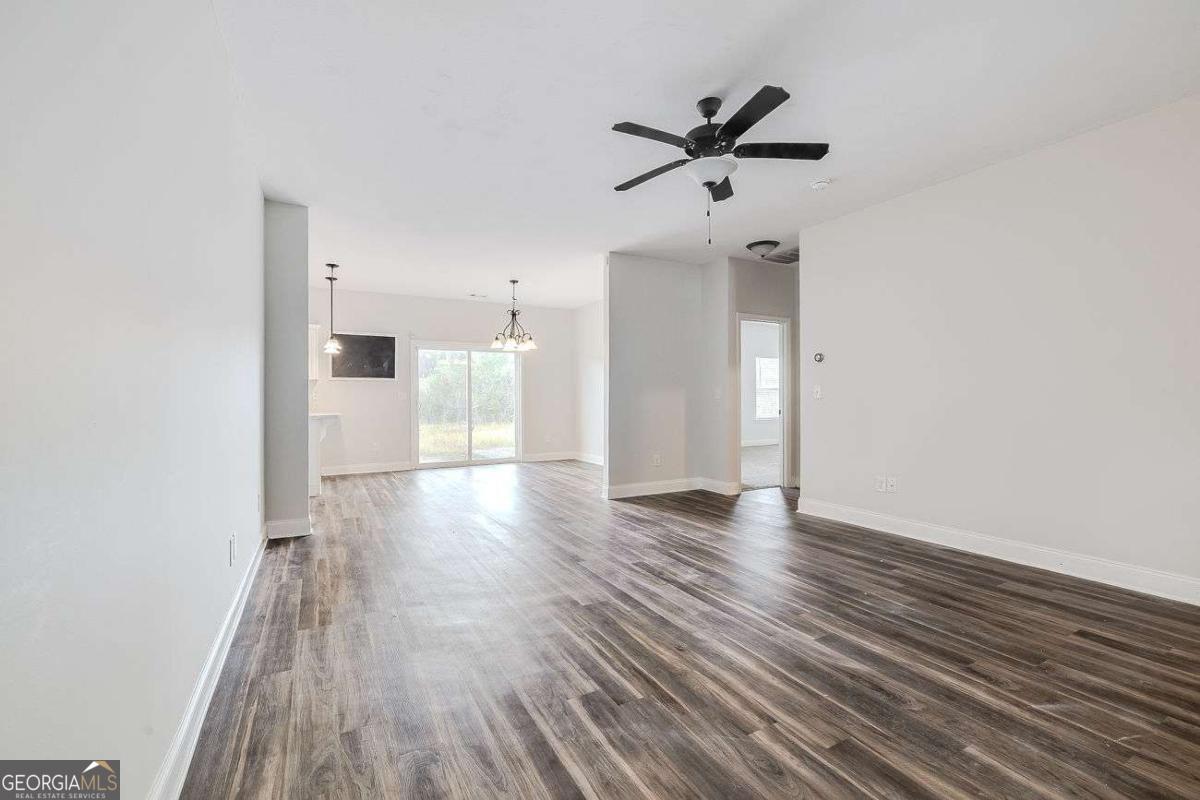 208 Timberlake Lane Guyton, GA 31312 - Photo 4 of 24 a view of a room with wooden floor and ceiling fan