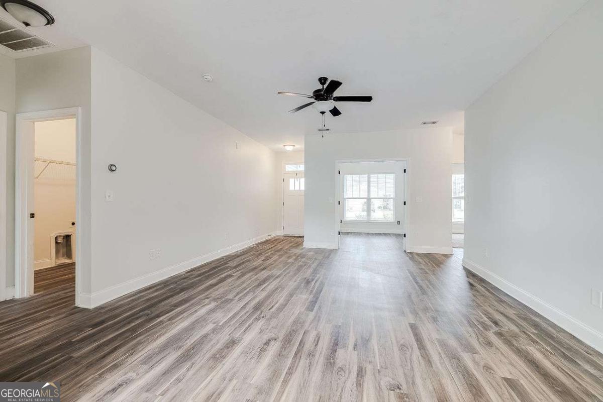 208 Timberlake Lane Guyton, GA 31312 - Photo 5 of 24 a view of empty room with wooden floor and fan