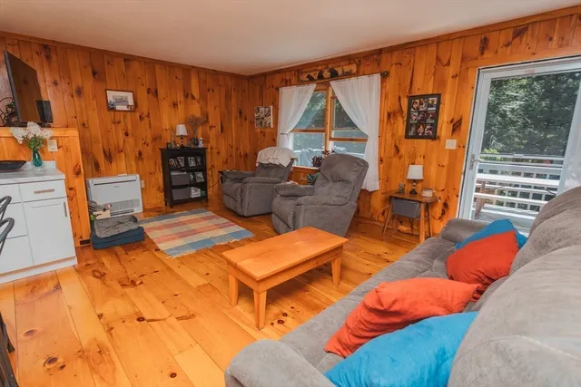 a living room with furniture a dining table and chairs with kitchen view