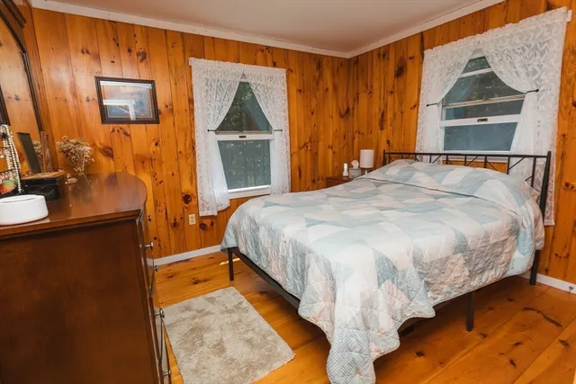 a bed sitting in a bedroom next to a window