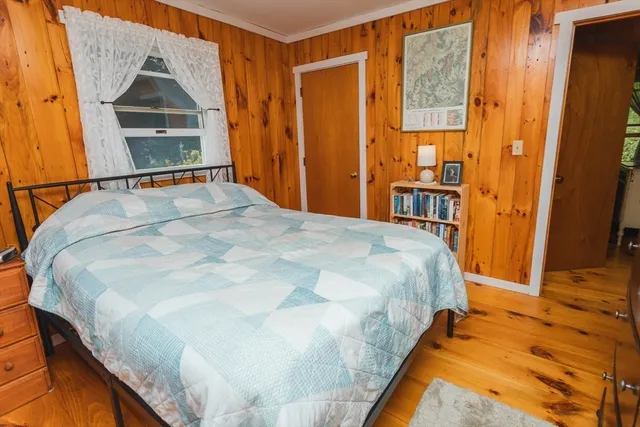 a bedroom with a bed and a dresser