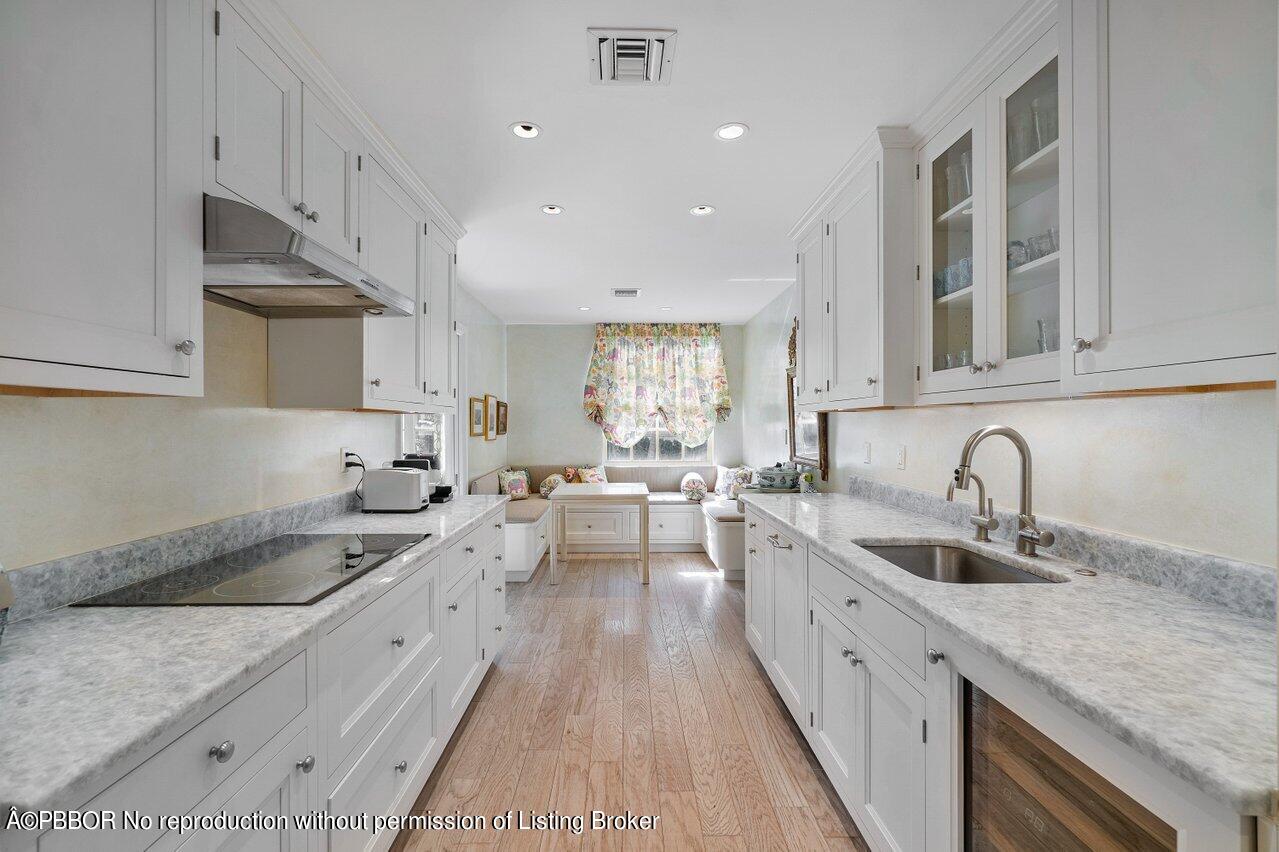 4333 North Ocean Boulevard, Unit BS2 Boca Raton, FL 33431 - Photo 7 of 22 a kitchen with sink stove and cabinets
