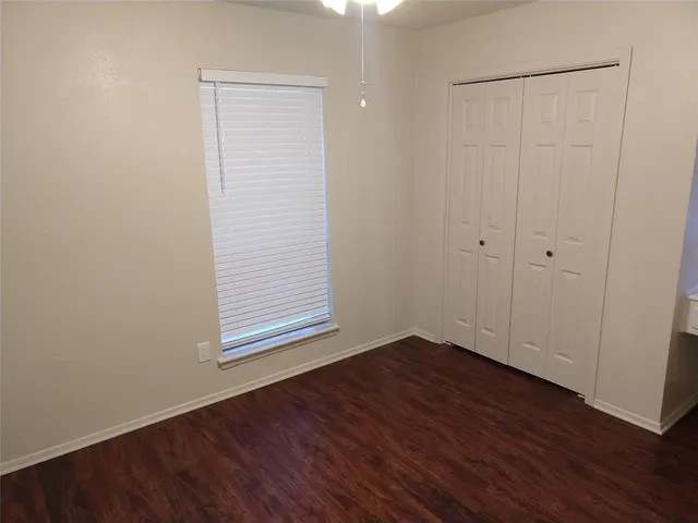 a view of room with window and wooden floor