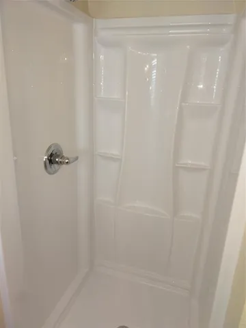 a bathroom with a glass shower door
