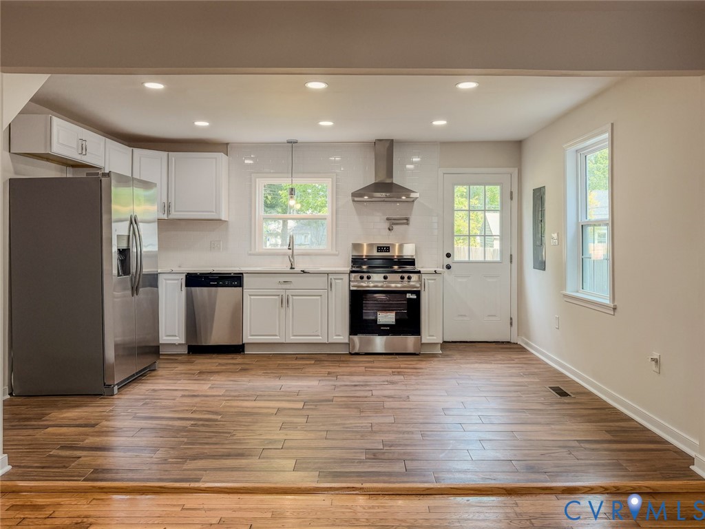 3409 Meadowbridge Road Richmond, VA 23222 - Photo 11 of 32 a kitchen with stainless steel appliances kitchen island granite countertop a stove a sink and a refrigerator