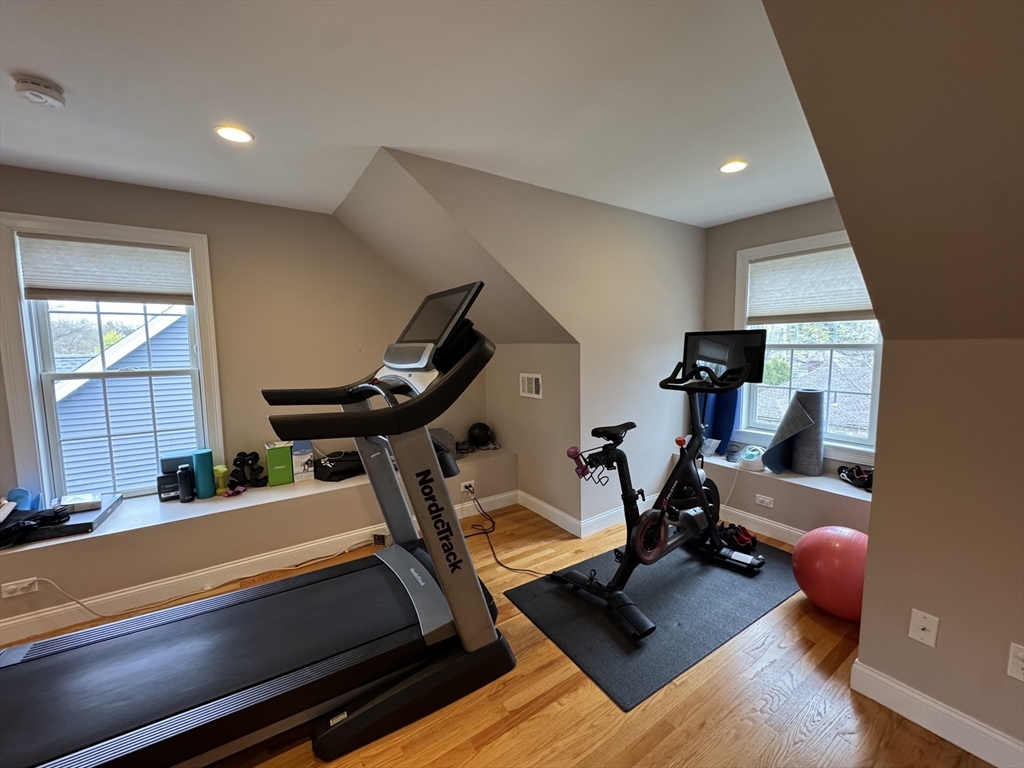 43 Canterbury Road Waltham, MA 02453 - Photo 18 of 42 a room with gym equipment and a large window