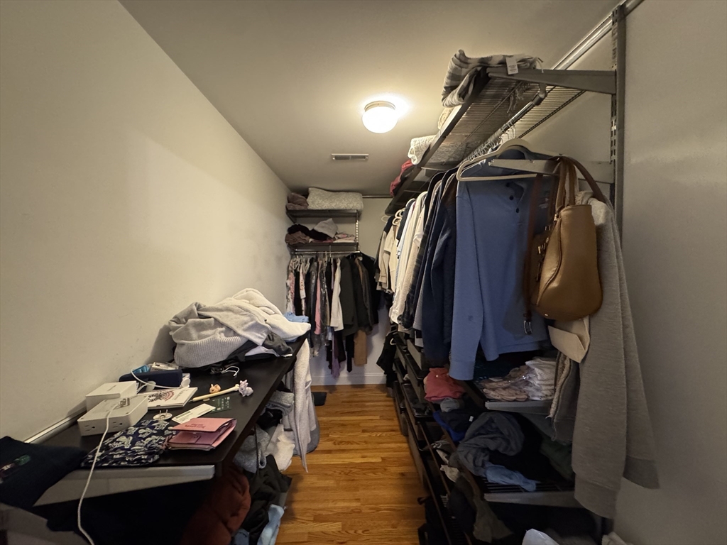 43 Canterbury Road Waltham, MA 02453 - Photo 22 of 42 a view of walk in closet with clothes and shoes