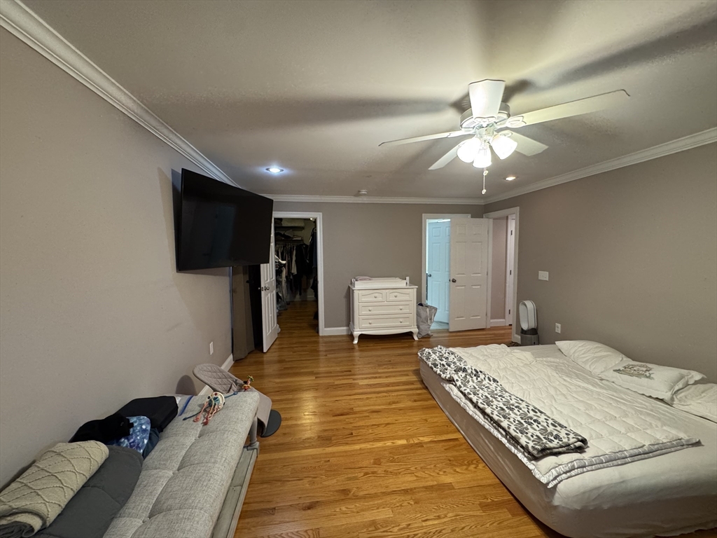 43 Canterbury Road Waltham, MA 02453 - Photo 25 of 42 a bedroom with a bed and a flat screen tv