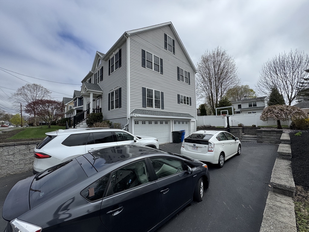 43 Canterbury Road Waltham, MA 02453 - Photo 42 of 42 a front view of a house with cars parked