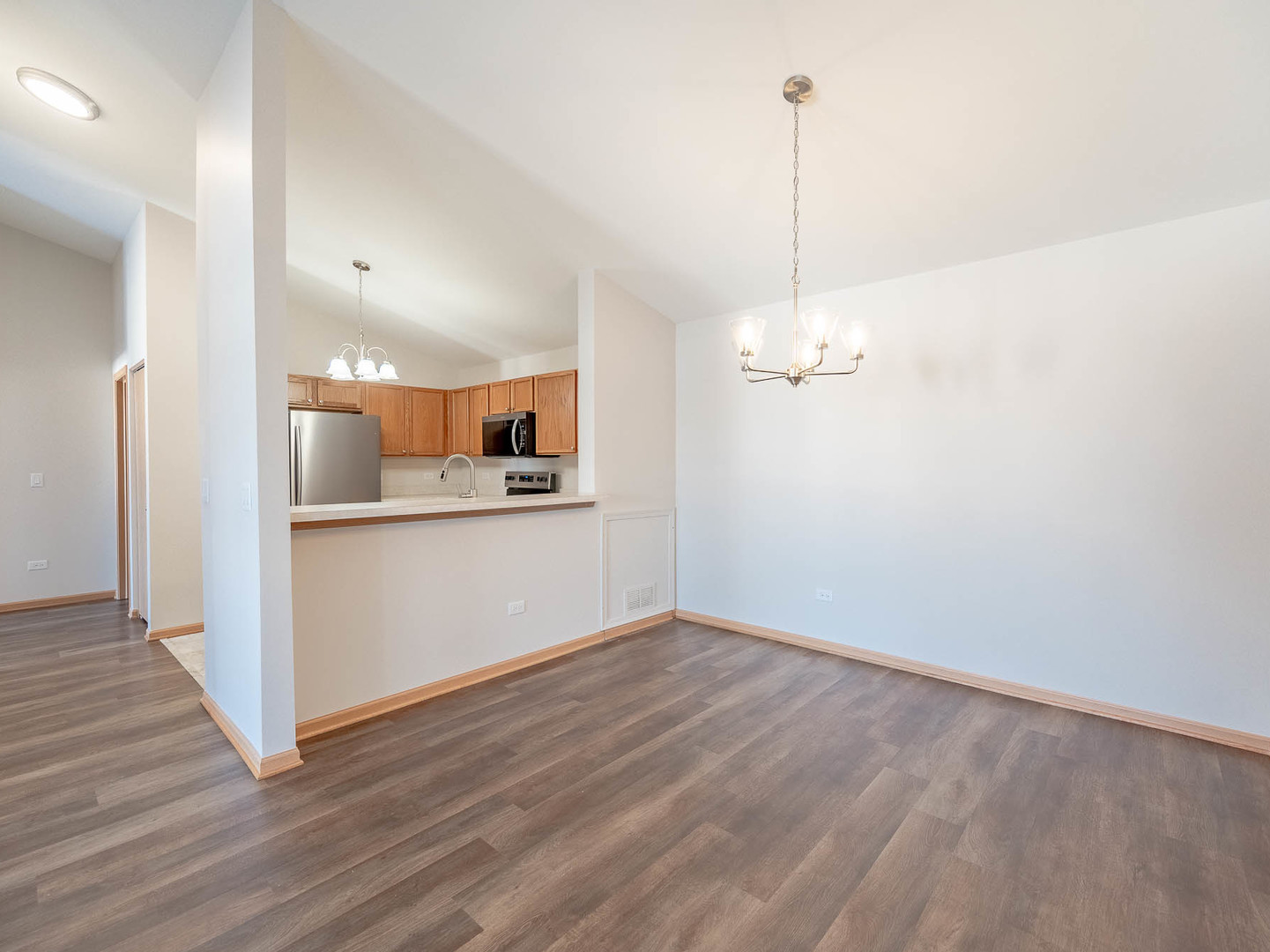 1648 McClure Road, Unit 1648 Aurora, IL 60505 - Photo 3 of 10 a view of a kitchen with refrigerator and wooden floor
