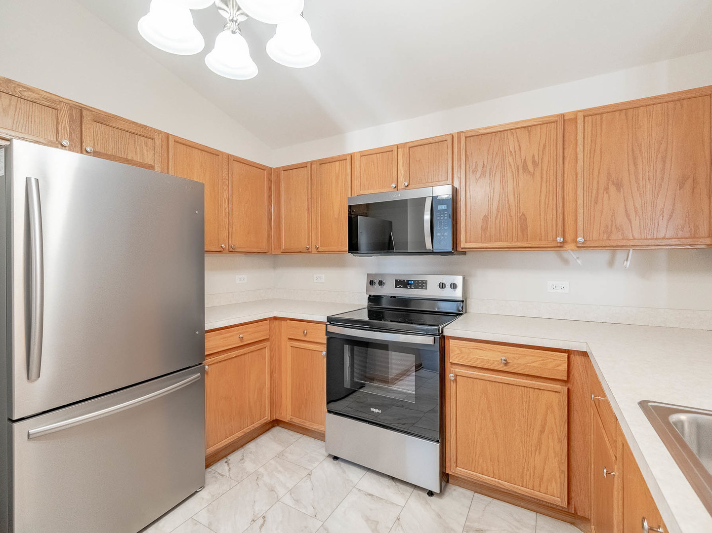 1648 McClure Road, Unit 1648 Aurora, IL 60505 - Photo 5 of 10 a kitchen with stainless steel appliances granite countertop a refrigerator stove top oven a sink and dishwasher