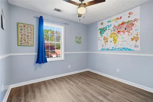 a view of room with window and wooden floor