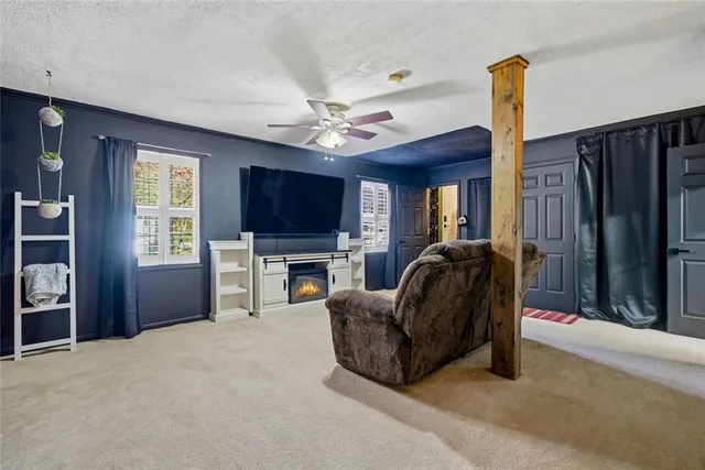 a living room with furniture a flat screen tv and a fireplace