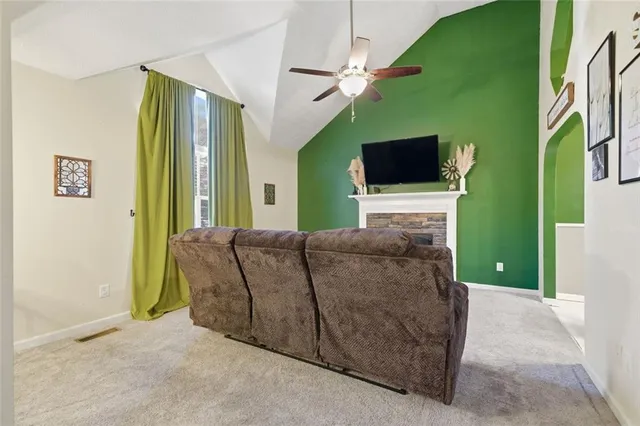 a living room with a flat screen tv and a fireplace