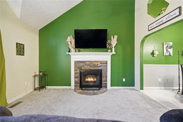 a living room with a fireplace and a flat screen tv