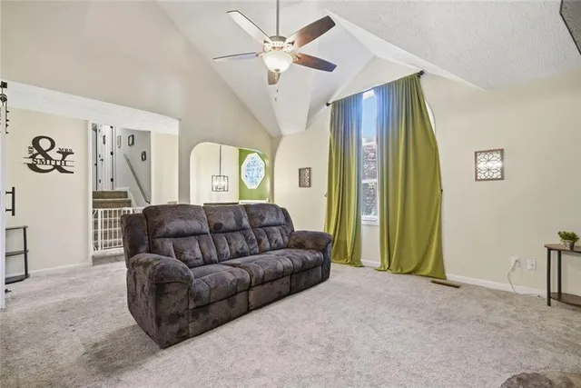 a living room with furniture and a ceiling fan