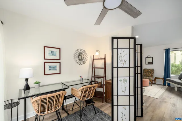 a living room with furniture a fireplace and a large window
