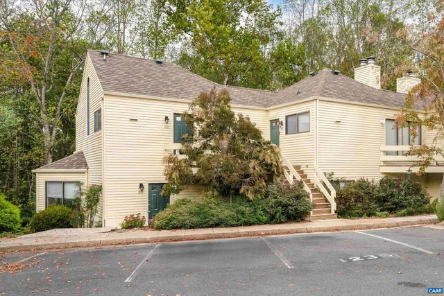 a house that has a tree in front of it