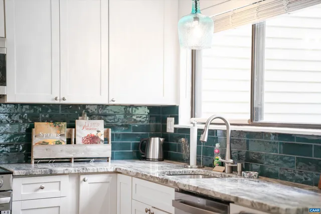 a kitchen with granite countertop cabinets stainless steel appliances and wooden floor