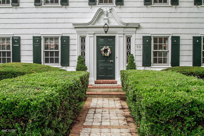 59 Indian Head Road Riverside, CT 06878 - Photo 3 of 28 a front view of a house with a garden