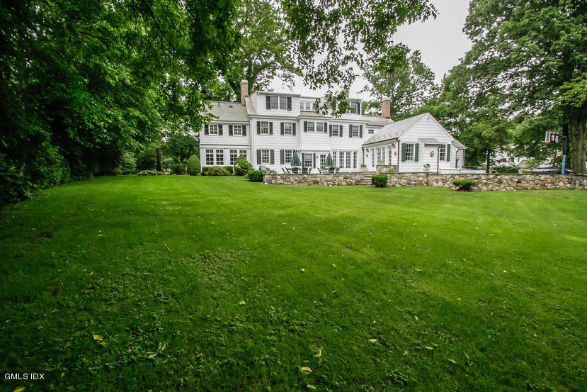 59 Indian Head Road Riverside, CT 06878 - Photo 4 of 28 a front view of a house with a garden