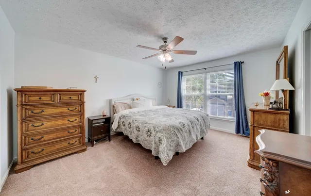 a bedroom with a bed dresser and a window