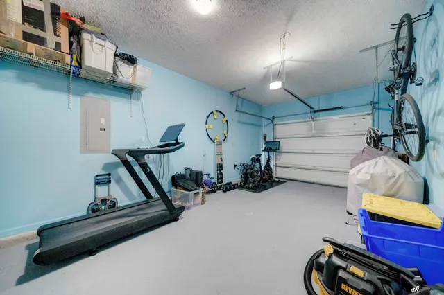 a view of gym equipment and a projector screen