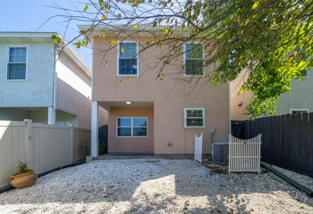 a view of a patio with table and chairs and wooden fence