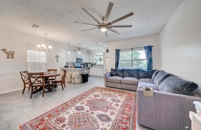 a living room with furniture and a dining table