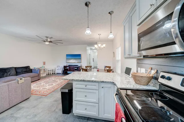 a kitchen with a stove and a white cabinets