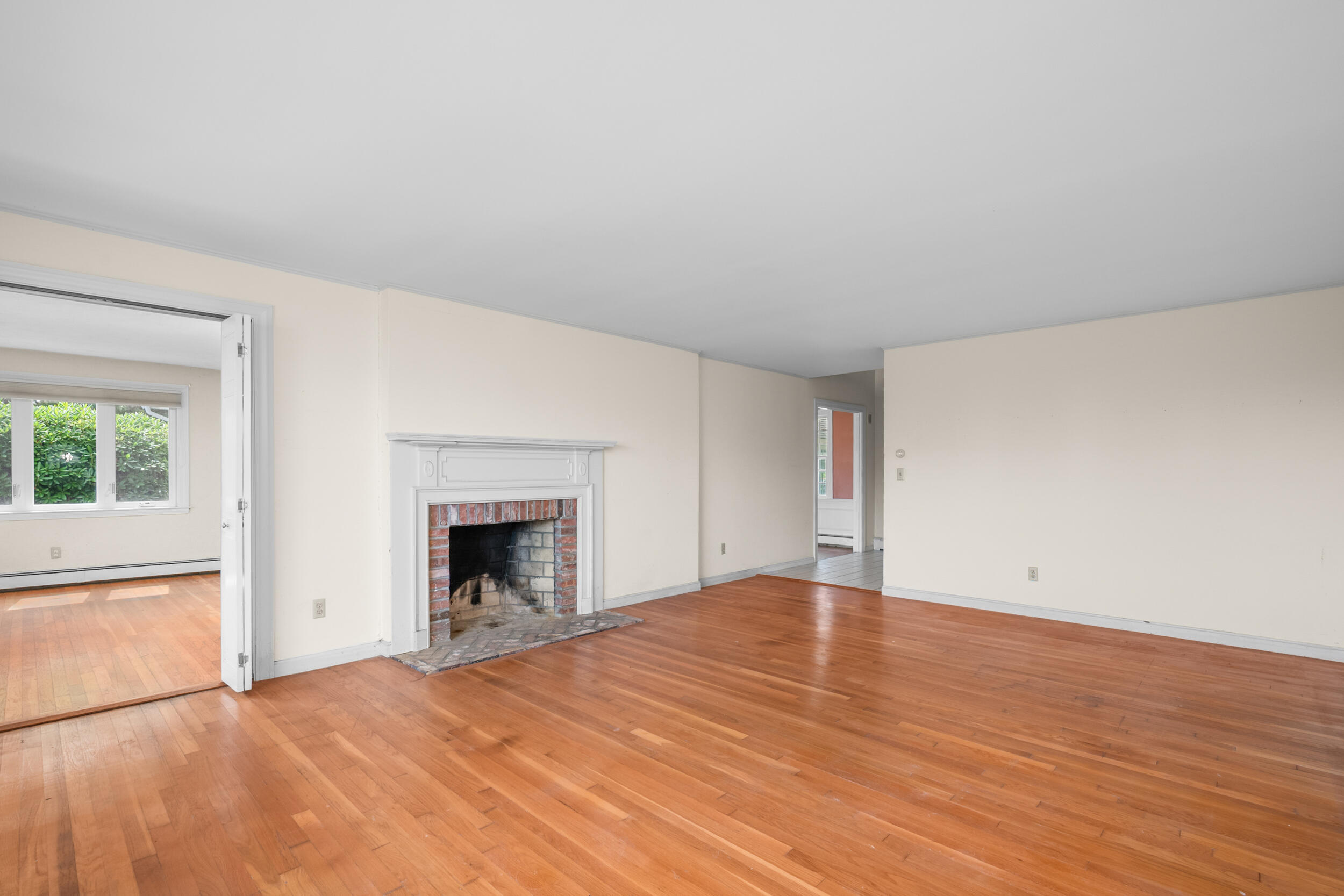 93 Harris Meadow Lane Barnstable, MA 02630 - Photo 19 of 64 a view of empty room with wooden floor and fireplace