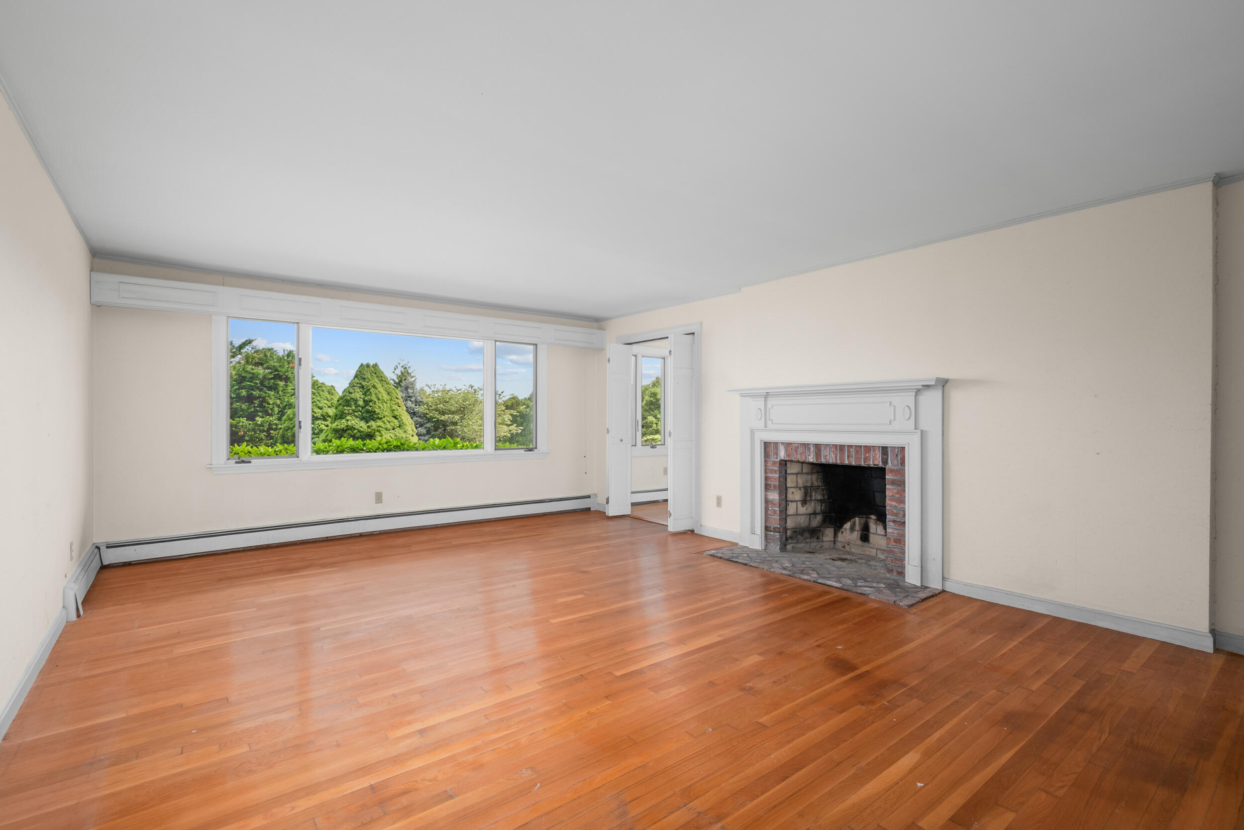 93 Harris Meadow Lane Barnstable, MA 02630 - Photo 20 of 64 a view of an empty room with wooden floor and a window