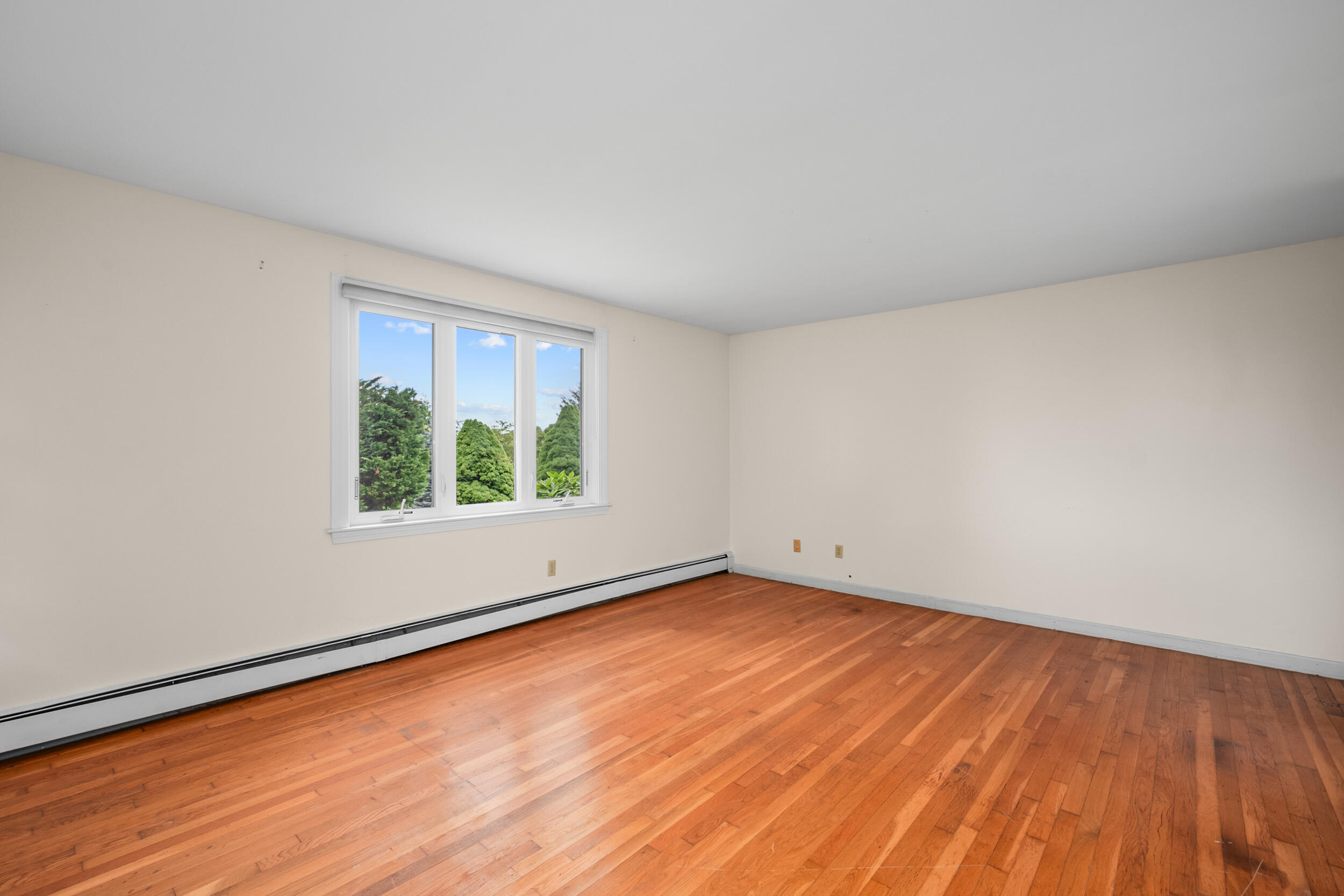 93 Harris Meadow Lane Barnstable, MA 02630 - Photo 23 of 64 a view of an empty room with wooden floor and a window