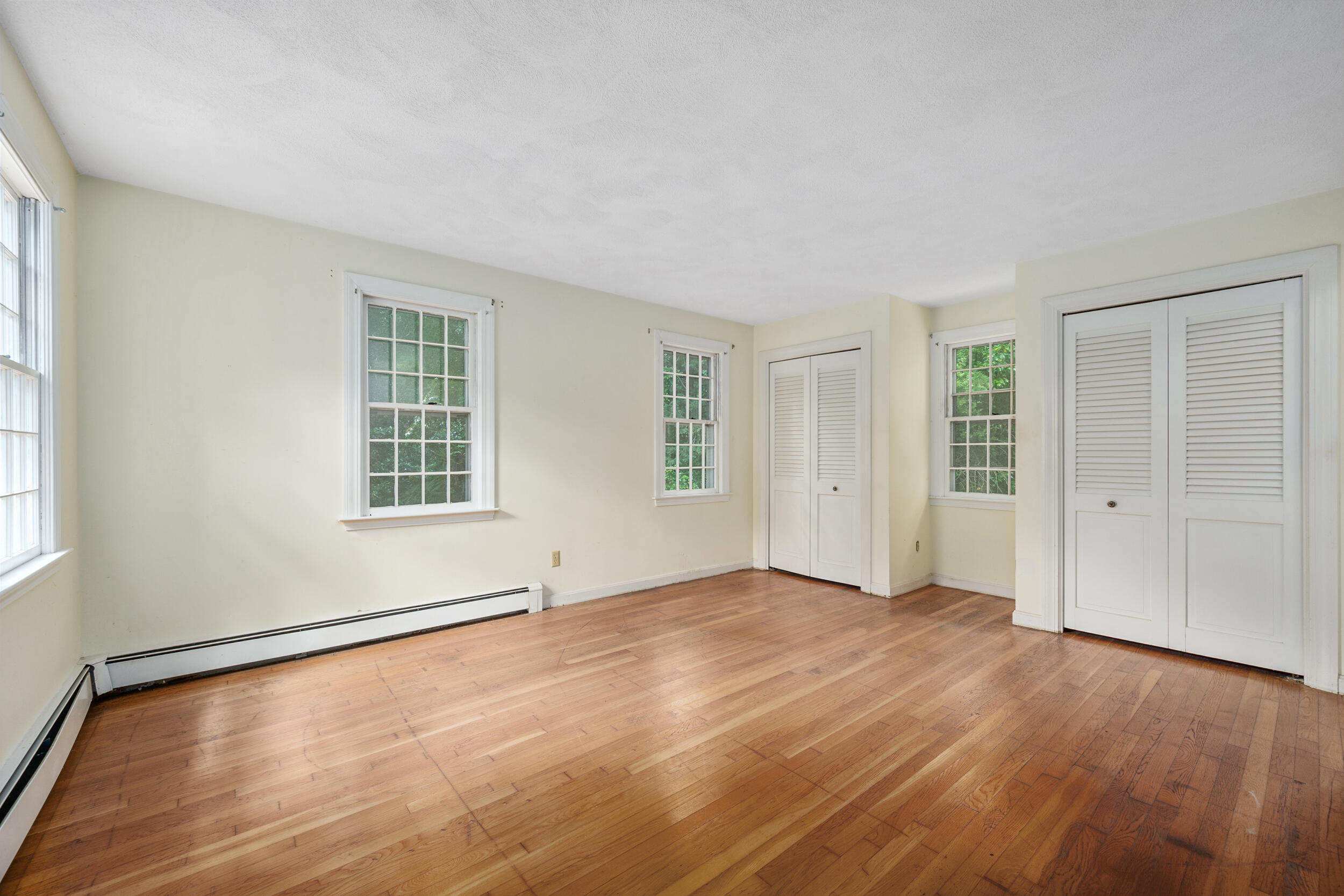93 Harris Meadow Lane Barnstable, MA 02630 - Photo 27 of 64 an empty room with wooden floor and windows