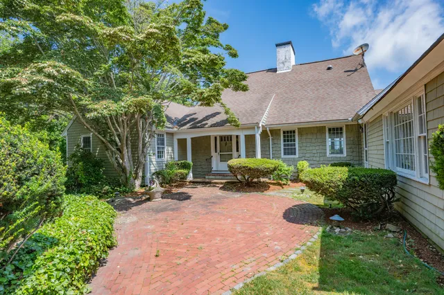 a view of a house with backyard sitting area and garden