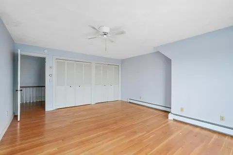 a view of an empty room with a fireplace and a window
