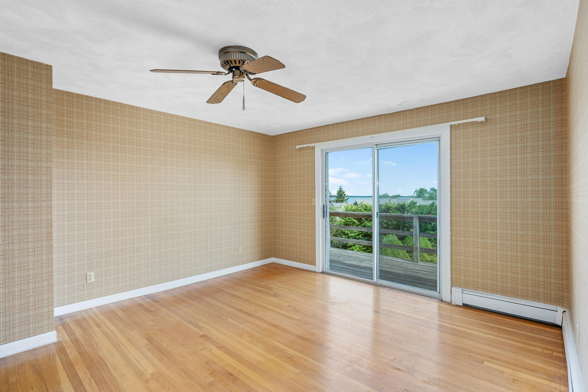 93 Harris Meadow Lane Barnstable, MA 02630 - Photo 37 of 64 a view of an empty room with wooden floor and a window