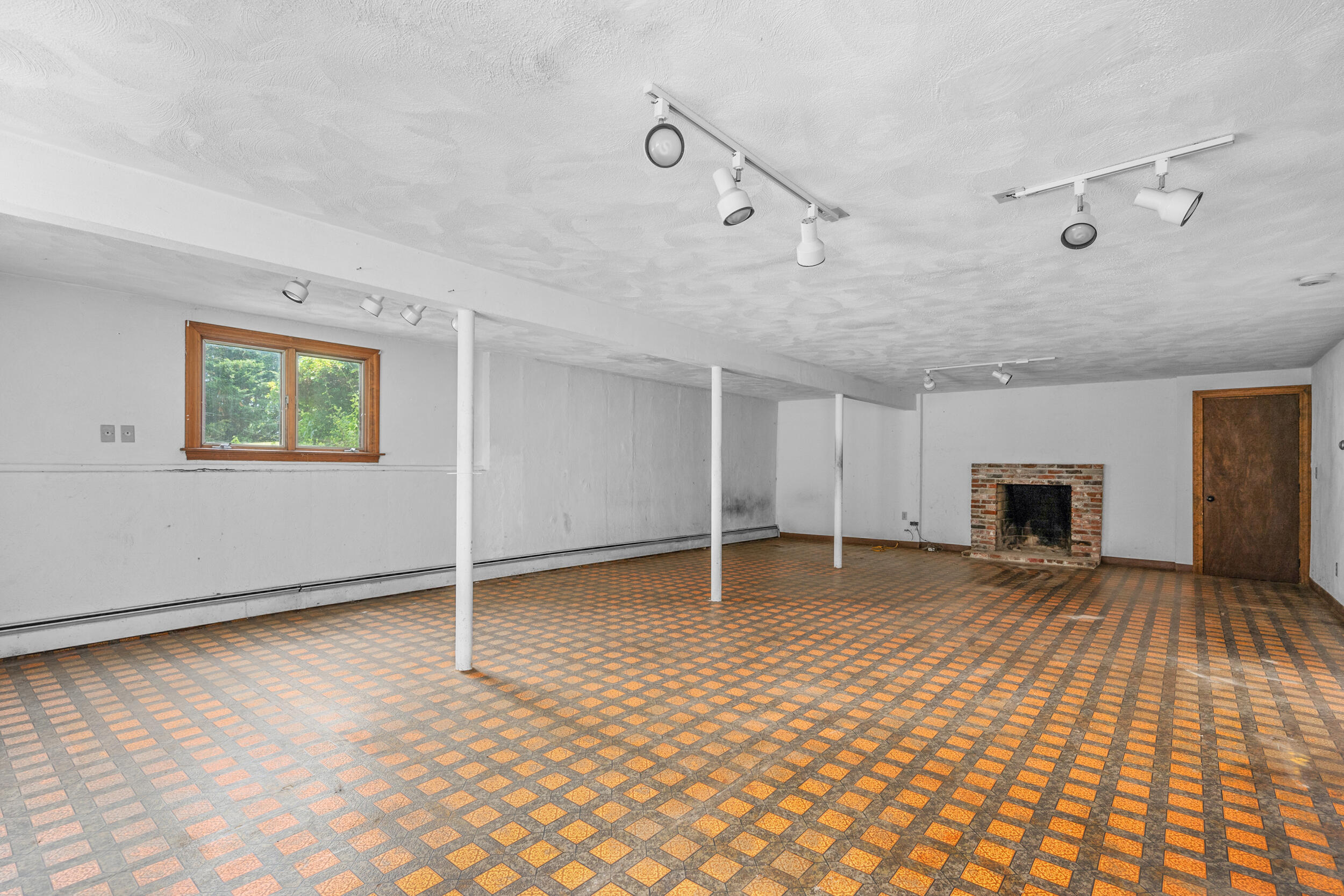93 Harris Meadow Lane Barnstable, MA 02630 - Photo 40 of 64 a view of an empty room with a fireplace and a window