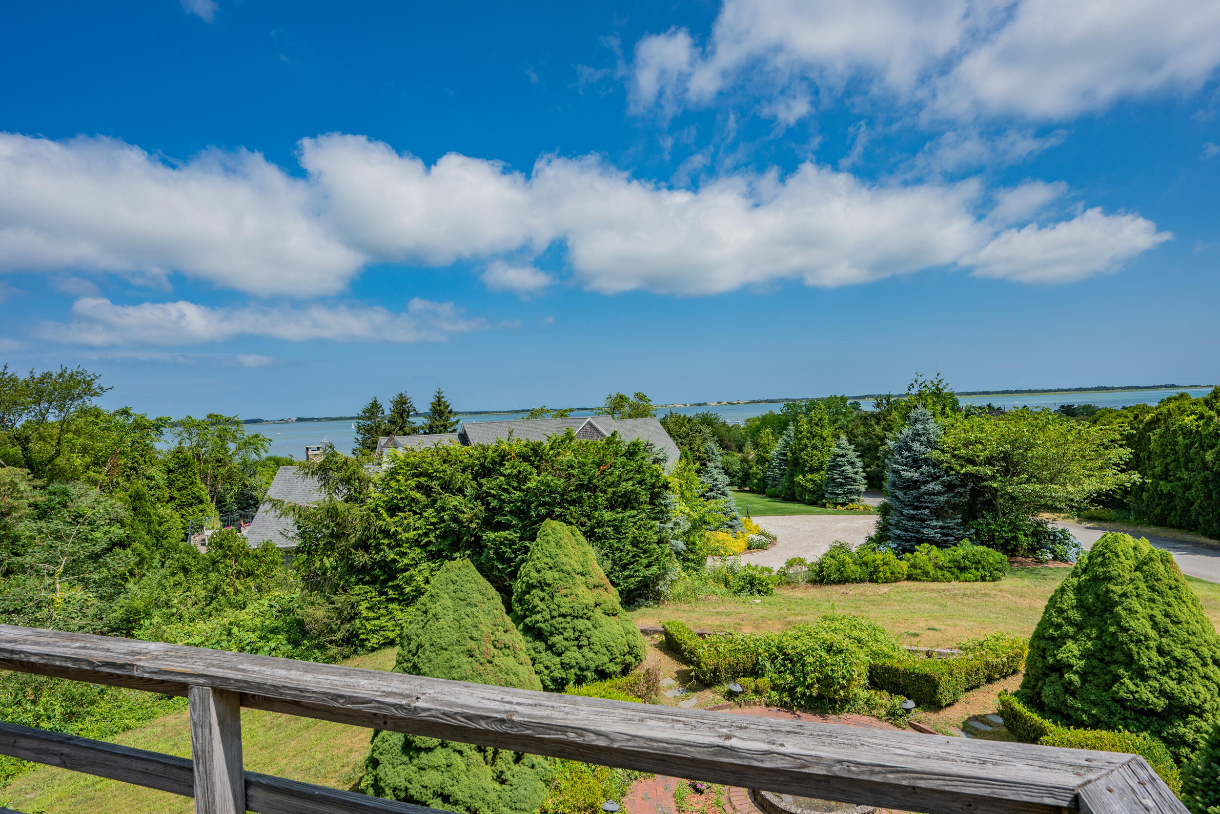 93 Harris Meadow Lane Barnstable, MA 02630 - Photo 41 of 64 a view of a yard with plants and wooden fence
