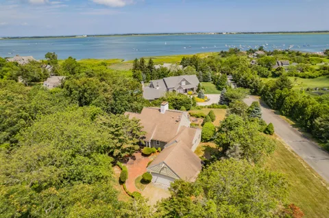 a view of a chair and table in backyard of the house