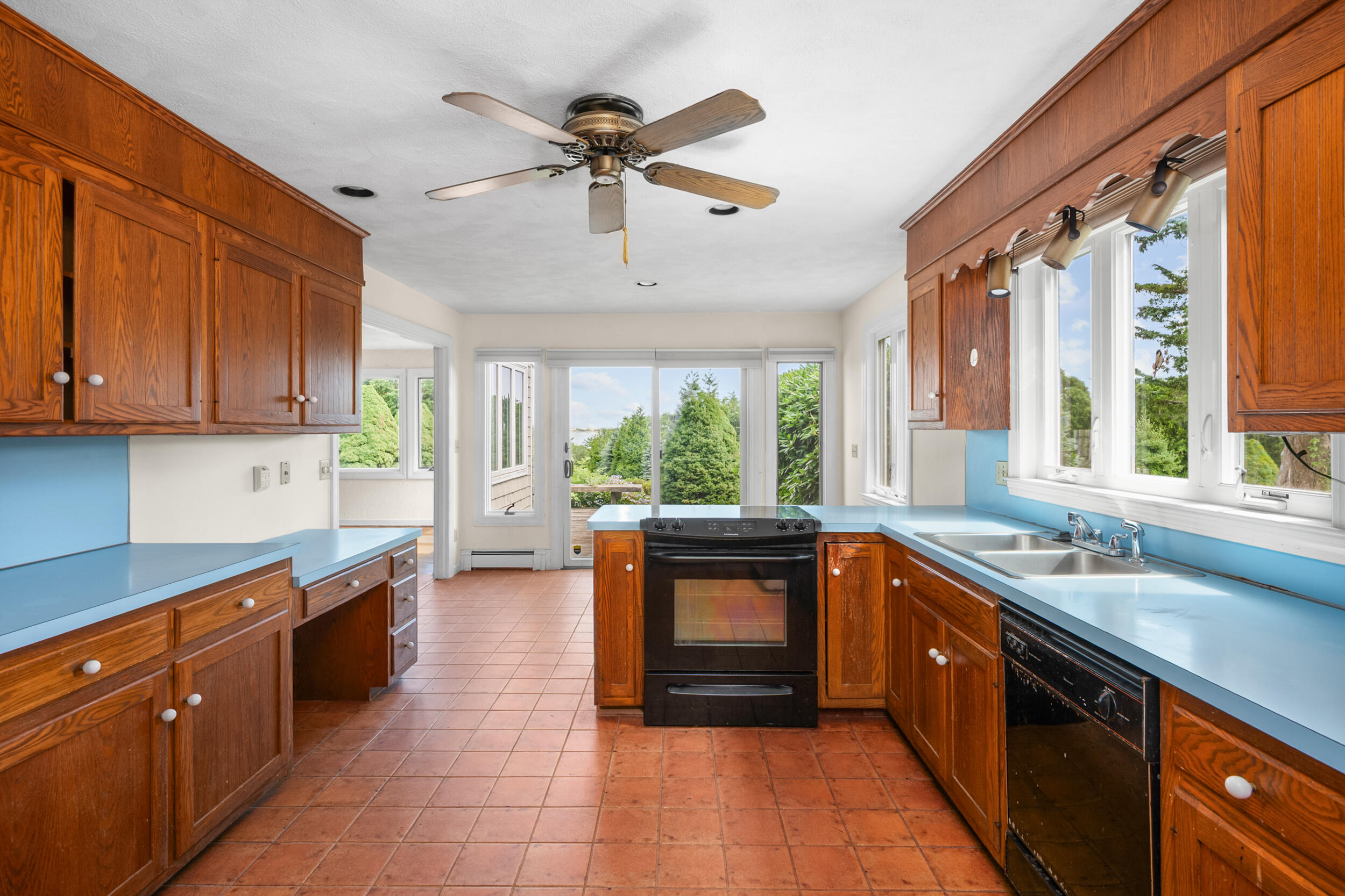 93 Harris Meadow Lane Barnstable, MA 02630 - Photo 9 of 64 a kitchen with a sink window and cabinets