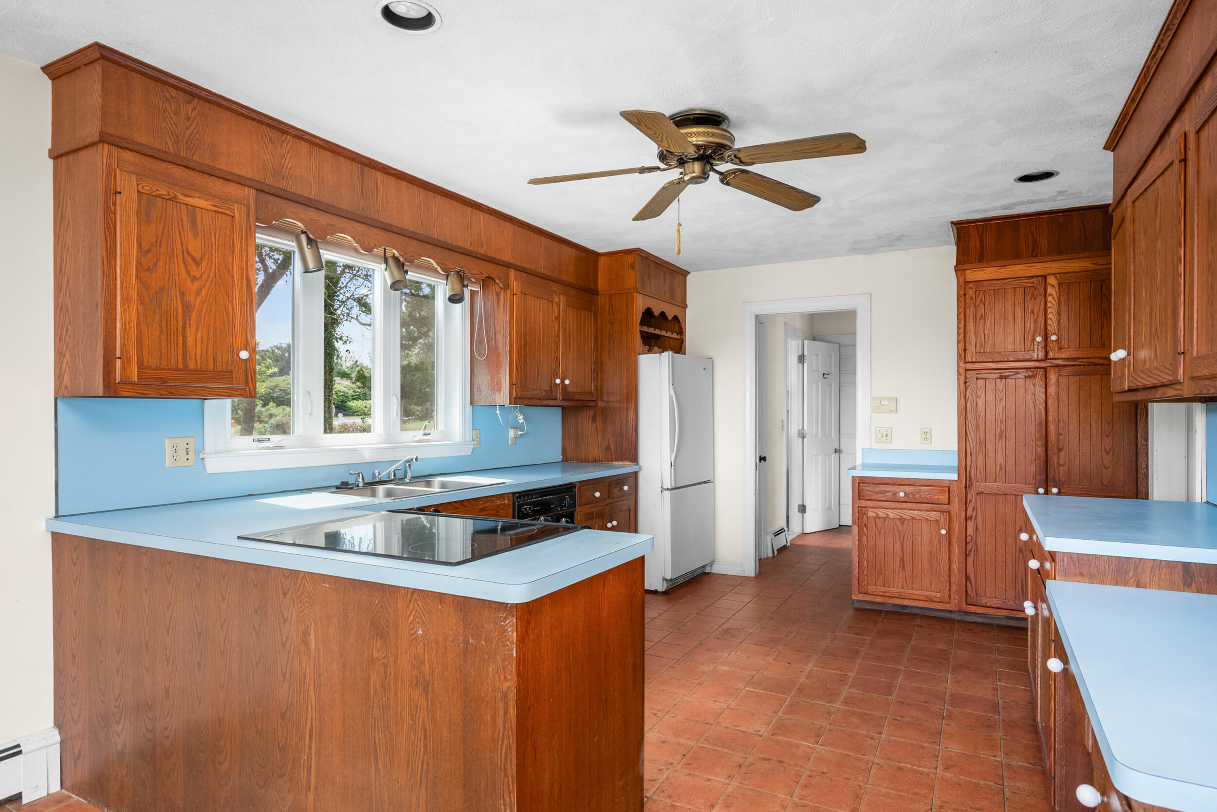 93 Harris Meadow Lane Barnstable, MA 02630 - Photo 10 of 64 a kitchen with a refrigerator a sink and dishwasher with a dishwasher next to a window